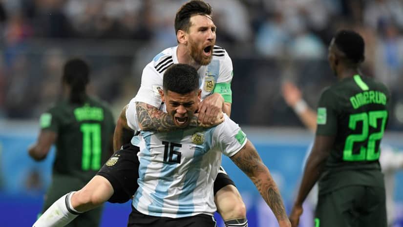 Marcos Rojo carrying Lionel Messi