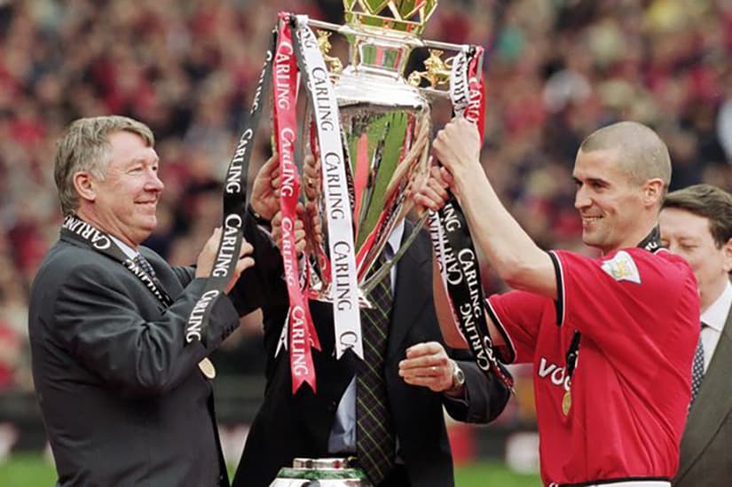 Manchester United manager Sir Alex Ferguson left lifts the league trophy with his captain Roy Keane