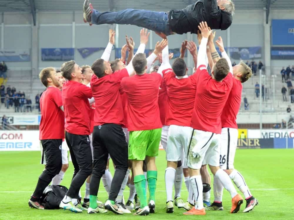 Freiburg players celebrate their coach Christian Streich